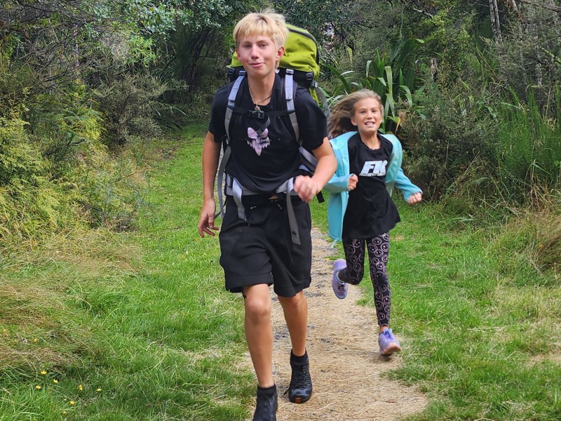 Kids running down a path